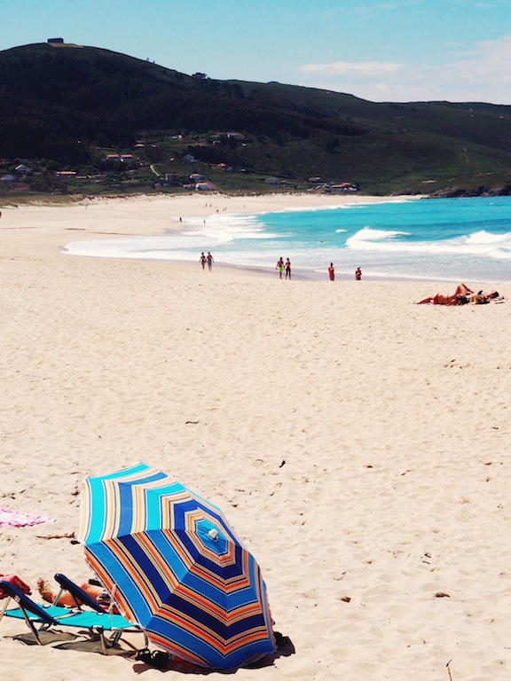 A solitary beach umbrella on Playa Doniños